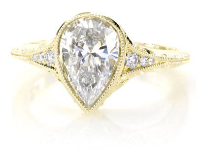 Antique engagement ring shown with a pear cut diamond in 18k Yellow Gold.