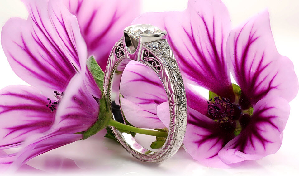 Indianapolis vintage inspired custom engagement ring featuring a round brilliant center diamond held in a half bezel setting with hand engraving, milgrain and filigree.