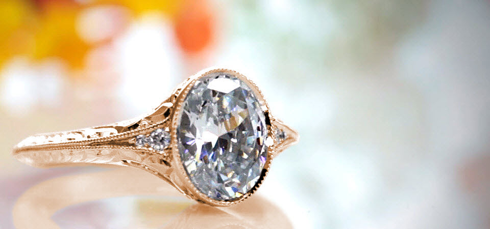 Rose gold engagement ring in Denver with oval center stone, filigree and milgrain.