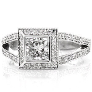 Regal Princess offers a lovely 0.75 carat princess cut diamond. The halo of micro pavé diamonds offers this stone a distinctively larger appearance. Curving to the top of the halo the split-shank compliments to its overall beauty. Hidden side diamonds add that perfect touch of flair.  