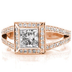 Regal Princess offers a lovely 0.75 carat princess cut diamond. The halo of micro pavé diamonds offers this stone a distinctively larger appearance. Curving to the top of the halo the split-shank compliments to its overall beauty. Hidden side diamonds add that perfect touch of flair.  