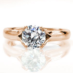 Our Dove design perfectly contours the 1.00 carat round diamond with a triangular split shank that seamlessly merges into the comfort fit band. The arched shoulders of the ring are upraised toward the center, and become part of the double prong. A soft 