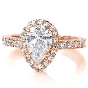 This breathtaking, vintage inspired design puts all the focus on the 0.75 carat pear cut center diamond. The center stone is nestled into a dazzling pear shaped halo. The halo and top of the band are adorned with lustrous micro pavé that will produce flashes of brilliant fire in any light.