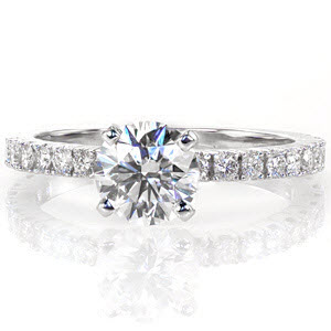The Fascination design has the best of heirloom quality and elegant styling. The single 1.00 carat round brilliant cut center diamond is prominently placed within four stately prongs. Handcrafted from 14k white gold, the band has unique split bead prongs.