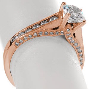 Rose gold engagement ring with round brilliant center stone and channel set diamonds in Cleveland. 