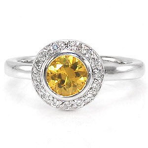 The luminous yellow of the sapphire center is a tantalizing vision to be seen. Micro pavé diamonds encircle the gemstone to enhance its beautiful golden hue. The sleek surface of the 14k white gold heightens the color of the delightful yellow sapphire.