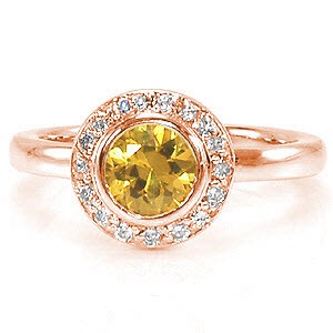The luminous yellow of the sapphire center is a tantalizing vision to be seen. Micro pavé diamonds encircle the gemstone to enhance its beautiful golden hue. The sleek surface of the 14k white gold heightens the color of the delightful yellow sapphire.