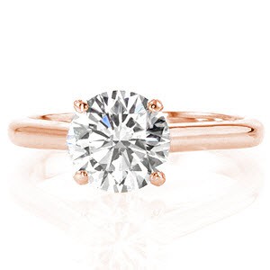 Tangiers is a modern solitaire design featuring 1.50 carat round brilliant. The straight uniform lines of the cathedral are fashioned just below the side of the diamond. The height of the mounting showcases the center stone for a refined statement. The 14k white gold metal shines from the high-polished finish. 