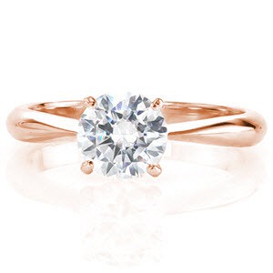Satin is a gorgeous contemporary solitaire with a 1.0 carat round brilliant diamond. Fashioned between four prongs, the lovely round center stone is a breathtaking sight. The band tapers towards the top of the ring placing all the attention on the exquisite diamond.  