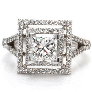 This geometric ring makes a grand statement with its luxurious double, square halos and split shank band. Both halos and the band are accented with micro pavé. The 1.00 carat princess cut center diamond is set in chevron prongs to protect the corners. This ring will dazzle with a prism of colors in any light!