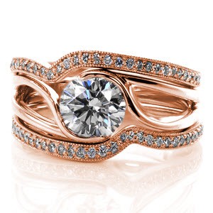 These matching diamond wedding bands symmetrically frame our Motion Engagement Ring. The micro pavé diamonds set on the top of each band add an elegant charm to the lines of the high polished gold band in the center. The milgrain texture along the edges of the wedding bands add a striking contrast. Price is for one band only.