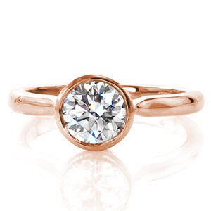 Delicado portrays a modern update of the classic solitaire. A full bezel setting cups a 0.75 carat round brilliant diamond to outline its circumference. The 14k white gold band tapers at the full bezel and the shoulders arch for a contemporary feel. The sleek high-polished finish enhances the brilliance of the diamond.