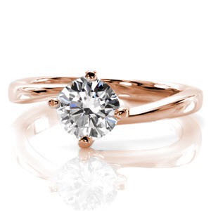 Milwaukee custom rose gold solitaire engagement ring with a round brilliant diamond held in a unique twisted setting.