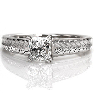 This design features clean lines and charming details to put all the focus on the 0.75 carat princess cut center diamond. The center stone is secured with double prongs and is upraised to show off the side profile of the stone. The wider band is adorned with a beautiful, hand engraved wheat pattern.