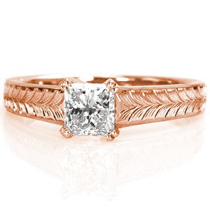 This design features clean lines and charming details to put all the focus on the 0.75 carat princess cut center diamond. The center stone is secured with double prongs and is upraised to show off the side profile of the stone. The wider band is adorned with a beautiful, hand engraved wheat pattern.
