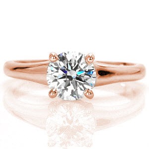 Flare Solitaire is a captivating 1.00 carat round brilliant contemporary engagement ring. The band widens to the top of the ring placing emphasis on the enthralling center stone. The smooth finish of the polished band magnifies the fire and luster of the diamond.