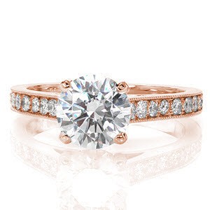 This pleasing heirloom-quality ring is designed to mesmerize. The band is richly detailed with larger micro pavé leading up to the 1.25 carat round brilliant center diamond. The edges of the band have been textured with milgrain which adds a tailored finish to this lustrous piece.