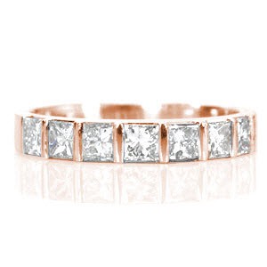Design 1540 features 7 half-bezel set princess cut diamonds totaling 0.80 carats. Each square stone is fashioned in a single row along the band and is evenly spaced between a bar of metal. This high polished band pairs beautifully with a princess cut solitaire or by itself for a modern right hand ring.