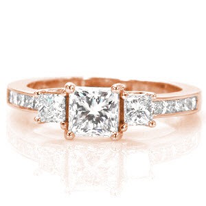 The Princess Beauty reflects classic styling of a three stone setting with an added flair of a trellis prong basket. The 0.75 princess cut center diamond is the center of attention with its sharp lines and geometric shape. Crafted in 18k white gold, the band is channel set with princess cut diamonds.