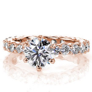 The Eternidad design encompasses luxury from every angle. The pronounced 1.00 carat round brilliant cut center diamond is captured within a classic 6 prong setting. Crafted in 14k white gold, the shared prong round diamonds create an endless band of sparkle.