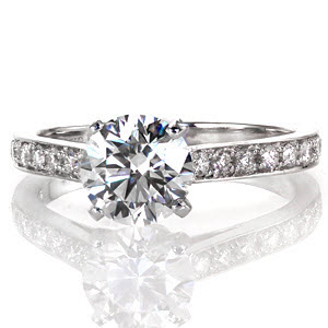Mariposa is a magnificent design featuring a 1.25 carat round brilliant cut center diamond in a cathedral setting. The band is elegantly appointed with large micro pavé diamonds and it gracefully curves up to meet the raised center stone; the way light dances off of the diamonds is simply divine.