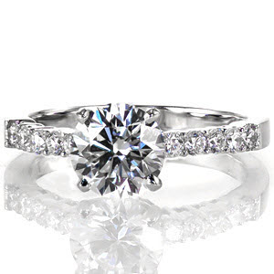 Emotion is a marvelous design featuring a 1.33 carat center stone. The band is adorned with five round diamonds for additional brilliance and fire. The slight raise of the cathedral heightens the band giving it a lovely side-view. High-polish edges adds luster and shine to enhance the beauty of all the diamonds.  