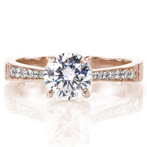 The Classique is a delightful design that uses subtle details to create a timeless look. The band is accented with micro pavé and tapers in as it reaches the 1.00 carat round brilliant cut center stone. The raised crown makes for a unique profile and milgrain provides a textured edge on the band.