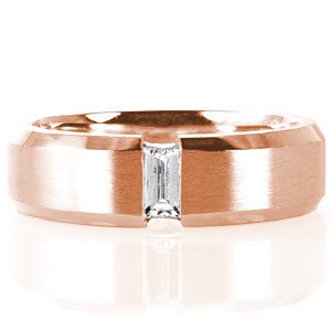 Crafted in 14k white gold, design 1636 has a modern presence and refined lines. The center of the band has a brushed finish that holds a center baguette diamond totaling 0.23 carats. Highlighting the center stone, beveled edges merge and hold the channel set diamond for added intriguing.  