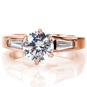 With six imperial, high polished prongs the Majestic design elevates a 1.00 carat round brilliant cut center diamond to be a dazzling center of attention. Crafted in 18k white gold, the broad band flares near the basket. Two tapered baguettes are bezel set within the band.