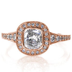 Graceful rounded edges of the micro pavé halo accentuate the cushion cut brilliant center. The bright white luster of the polished sides compliment the bezel securely fashioning the 1.00 carat cushion. Diamonds graduate in size as the band flares to the top of the ring for a magnificent top view.