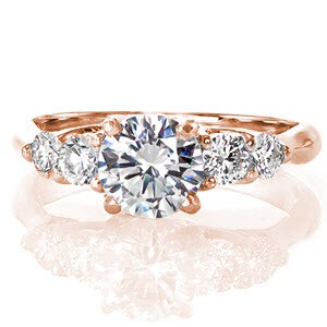 A timeless five stone design with an elegant profile revealing an interwoven setting. The Contour Five Stone Trellis features a 1.00 carat round brilliant with four round diamonds on each side of the center stone. Crafted in 14k white gold, the band shoulders contour and delicately arch for comfort.