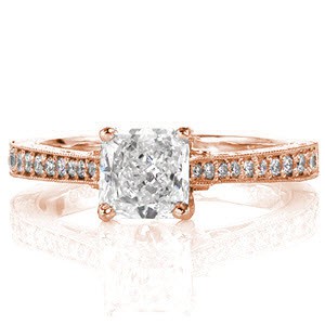 This intriguing vintage-inspired design featurs a 0.75 carat radiant cut center diamond elevated above an intricately detailed band. The top is decorated with micro pavé diamonds and milgrain. The side face reveals beautiful hand engraving, filigree curls and a beautiful diamond petal pattern.