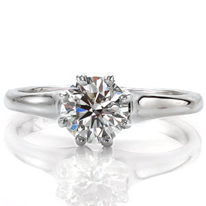 The Vitoria is an elegant solitaire design. The eight prong setting is a decorative element chosen to provide an antique flare to the ring. The band flares out as it reaches the center stone setting and is finished with a high polish. The center stone can be customized in shape, size, and stone type.