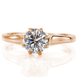 The Vitoria is an elegant solitaire design. The eight prong setting is a decorative element chosen to provide an antique flare to the ring. The band flares out as it reaches the center stone setting and is finished with a high polish. The center stone can be customized in shape, size, and stone type.