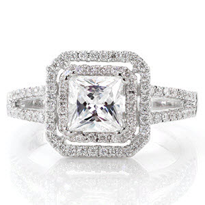 Cassandra is a diamond lover's dream. A double halo of micro pavé diamonds frames the 1.0 carat princess cut, adding beautiful radiance and incredible width. The micro pavé diamonds continue along the delicate split-shank band. Milgrain chevron detail adds intrigue and uniqueness under the halo. 