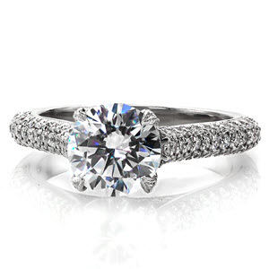 Micro pave engagement ring in Hastings with round brilliant center stone and three rows of diamonds along the band.
