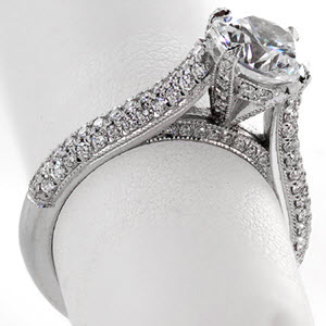 Charlotte micro pave engagement ring with rows of diamonds and round brilliant center stone.