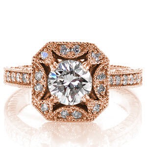 The Lotus inspired halo features half moon crescents detailed with micro pavé diamonds. A 0.90 carat round brilliant diamond is featured in the halo center. Round stones embellish the band on three sides and textured hand engraving adds a vintage appeal. Milgrain lines every edge for a decorative appeal.