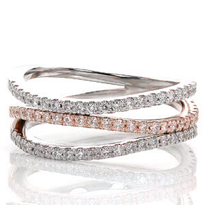 Pink Fuego has a delicate balance of warm 14k rose gold and crisp white gold. The serene wave of the three micro pavé diamond bands accent the graceful flow of the ring. For a comfortable fit, the bands are joined as one at the bottom of this wide and airy band.