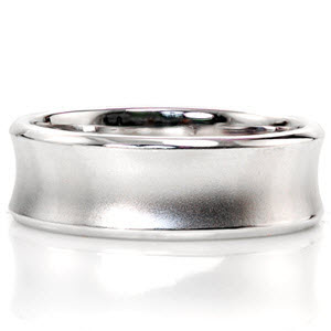 This concave design uses texture to create detail. The outer edges are sleek with a high polish while the middle of the ring is sand blasted with a matte finish. The inside of the ring is slightly rounded for comfort. This 14k white gold design can be customized in width and metal type. 
