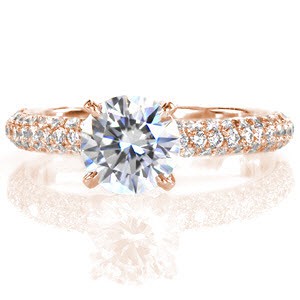 Sonata is a classic and sophisticated ring. A delicate four prong crown holds a 1.0 carat round brilliant diamond. The three rows of micro pavé diamonds along the band add tremendous radiance when the light reflects along the stones. The band has a round comfort fit profile for additional softness.