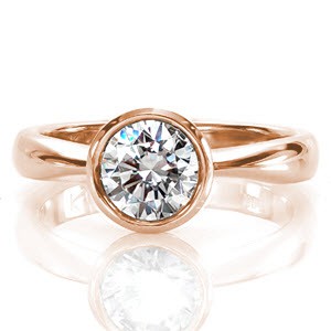 The Eclipse design is a modern solitaire that proudly displays a 1.00 carat round brilliant diamond in an eye-catching full bezel setting. A reverse taper shank decorates with clean lines that draw the eye towards the center stone. A high polish finish adds radiance and shine.