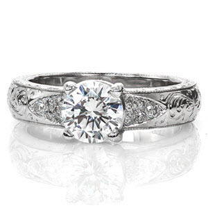 Toulon is an enthralling design with unique hand-carved engraving along the top of the band. The 0.90 carat round brilliant diamond is bordered on either side by an array of micro pavé. The wide band is slightly rounded and features a delightful hand engraved wheat pattern on both sides of the ring.