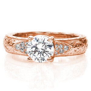 Toulon is an enthralling design with unique hand-carved engraving along the top of the band. The 0.90 carat round brilliant diamond is bordered on either side by an array of micro pavé. The wide band is slightly rounded and features a delightful hand engraved wheat pattern on both sides of the ring.