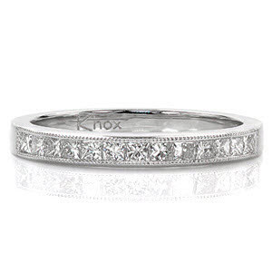 The top of this delicate band is channel set with a row of princess cut diamonds. The straight lines of the stones are perfectly framed by a beaded milgrain texture. Princess Petite is a classic design that can be paired with a variety of engagement ring styles. 