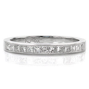 The top of this delicate band is channel set with a row of princess cut diamonds. The straight lines of the stones are perfectly framed by a beaded milgrain texture. Princess Petite is a classic design that can be paired with a variety of engagement ring styles. 