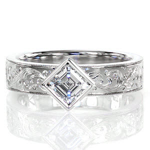 Des Moinse wide band engagement ring with kite-set asscher cut center stone and scroll engraved band.