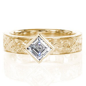 Custom engagement ring in El Paso with a bezel kite set asscher cut center diamond paired with a hand engraved scroll patterned band.