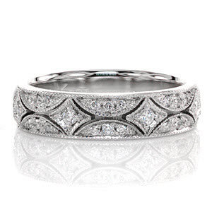 The Polaris design presents a timeless elegance inspired by the stars. The starbursts down the middle of the band are each accented by a round brilliant cut diamond. The surrounding half moons are detailed with micro pavé diamonds that produce vibrant flashes of rainbow color. Each section is edged with milgrain. 