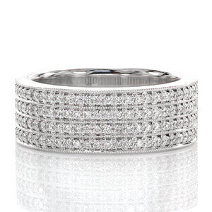 This magnificent wide band is lavished in 4 rows of micro pavé. Each round brilliant cut diamond is prong set by hand, and each row of stones is separated by a line of milgrain texture. This beaded pattern adds a refined finish that blends the stones together to create a gorgeous ring that dances in the light.